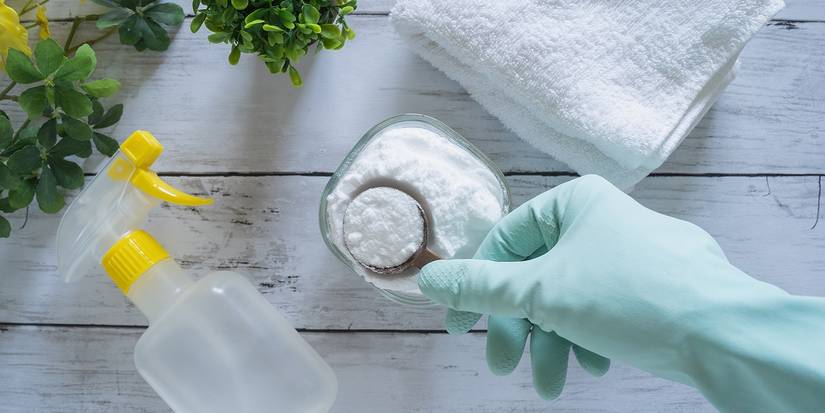 baking soda in a jar next to plant and spray bottle