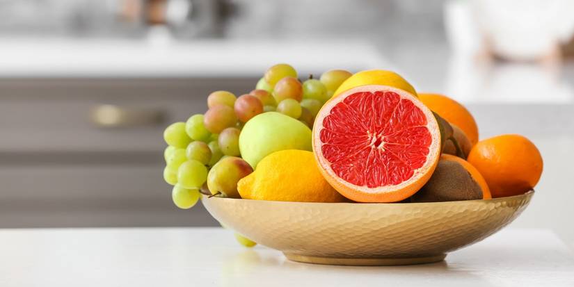 Bowl of fruit sitting on a kitchen table