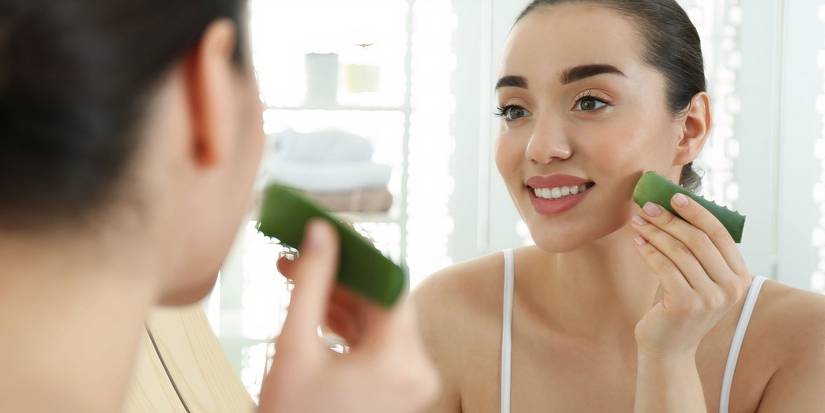 Applying aloe vera on the face