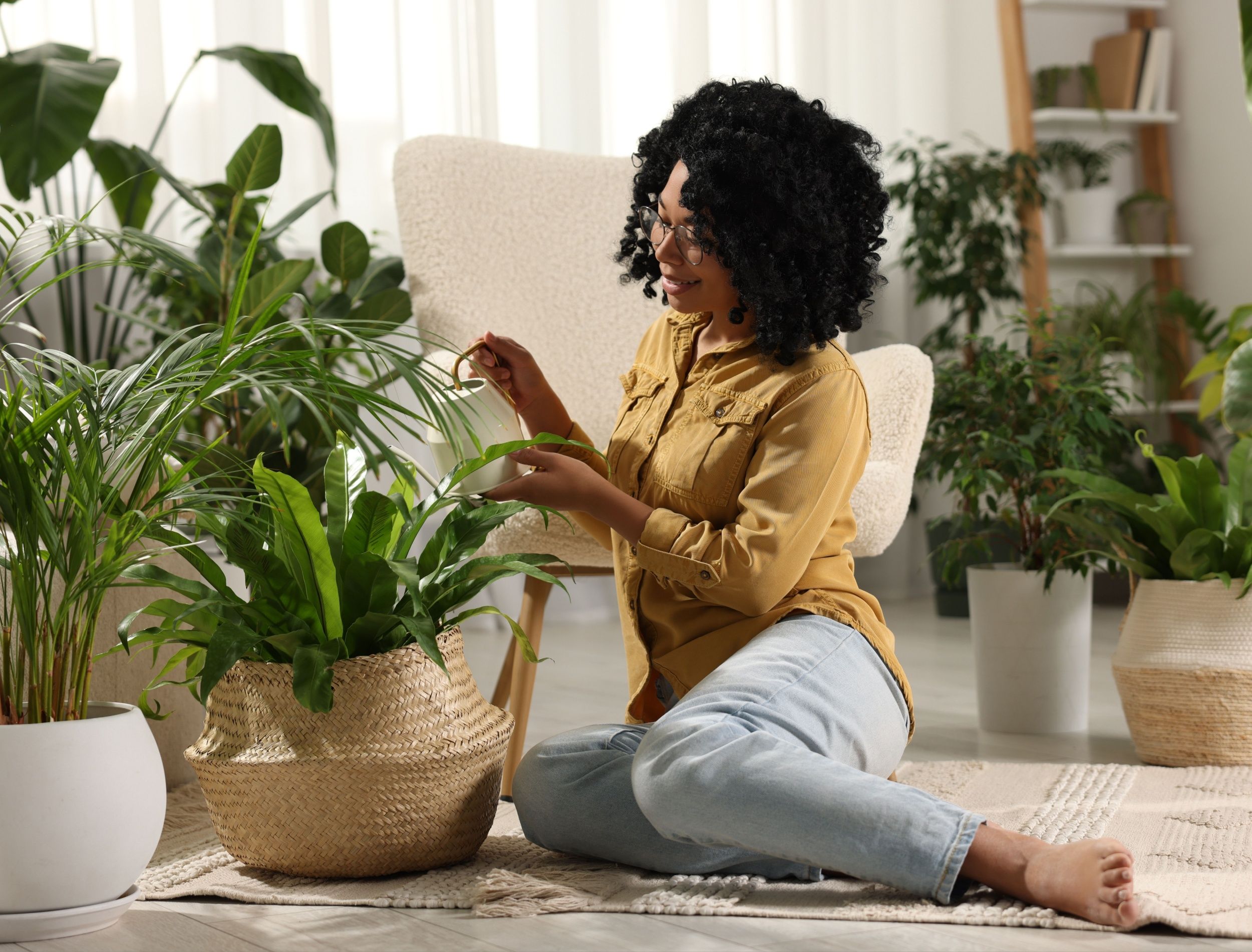 Woman watering her multiple houseplants